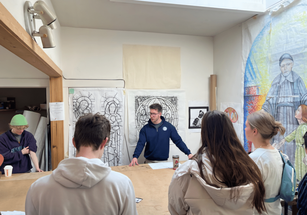 3 people surrounding a table